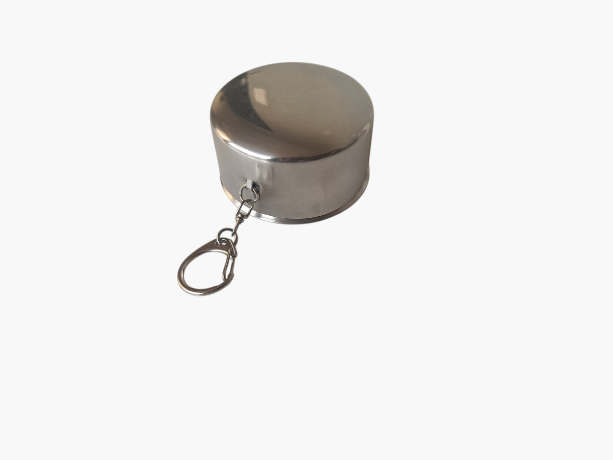 Campus Zone collapsible stainless steel travel cup in a compact, folded position with an attached keychain ring.