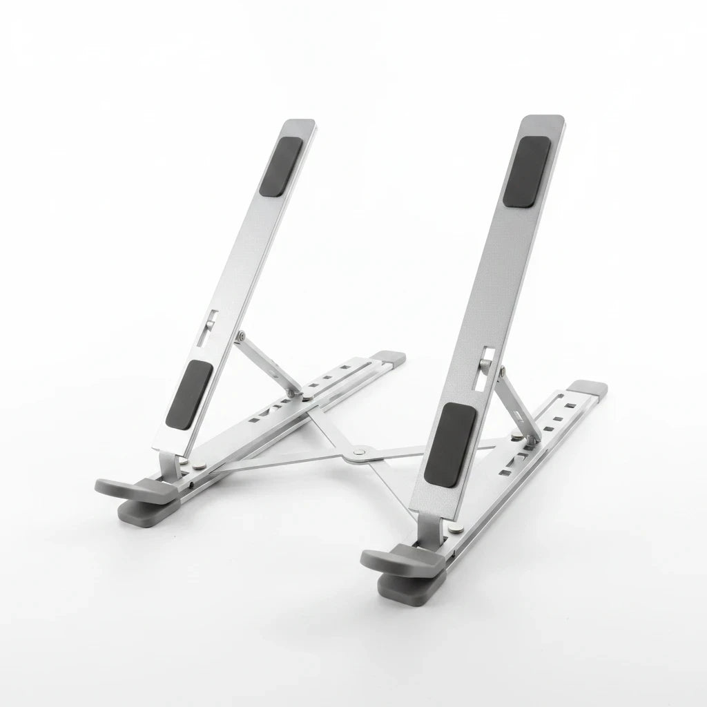 Campus Zone silver aluminium foldable laptop stand with adjustable X-brace mechanism and protective rubber grip pads.