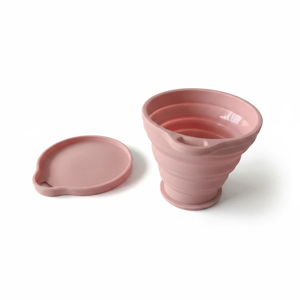 Campus Zone pink collapsible silicone travel cup with matching lid, perfect for compact and eco-friendly hydration.