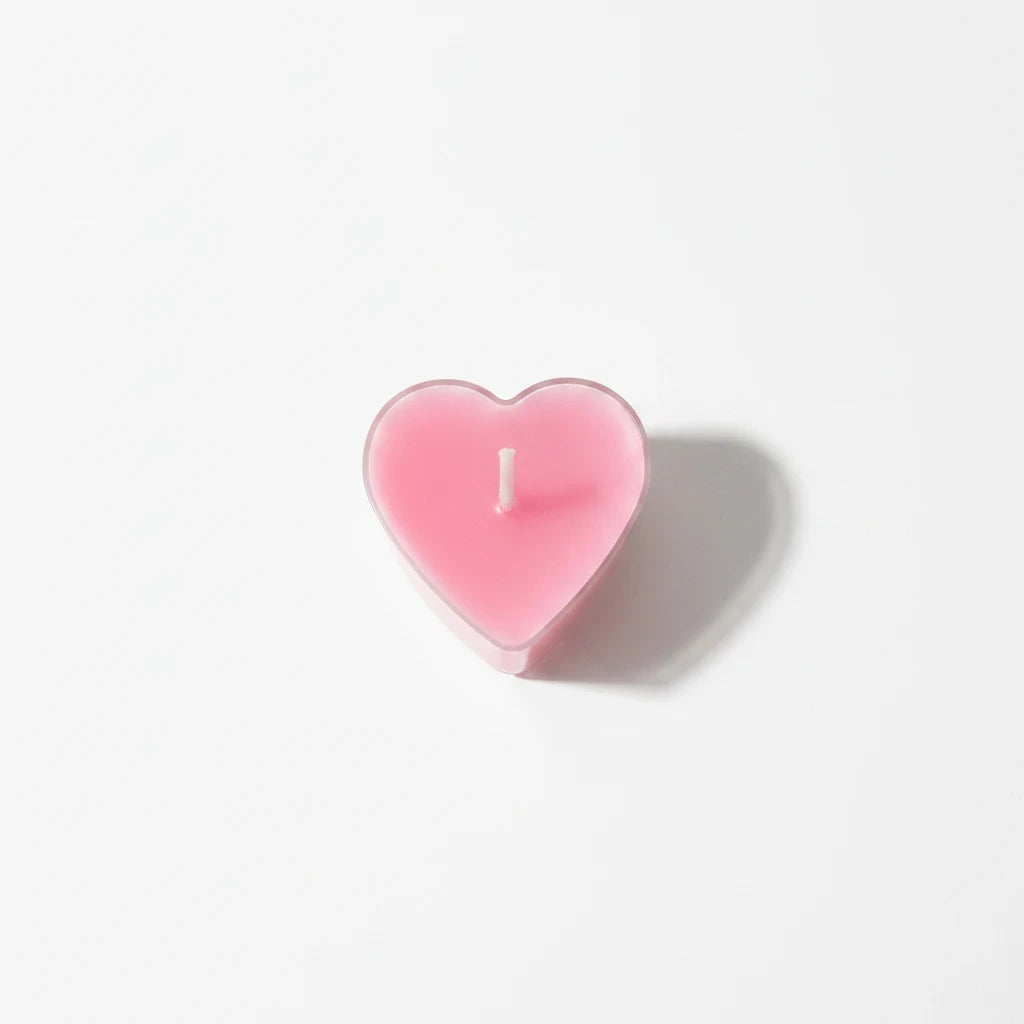 Campus Zone heart-shaped pink tea light candle in a clear plastic holder on a white background