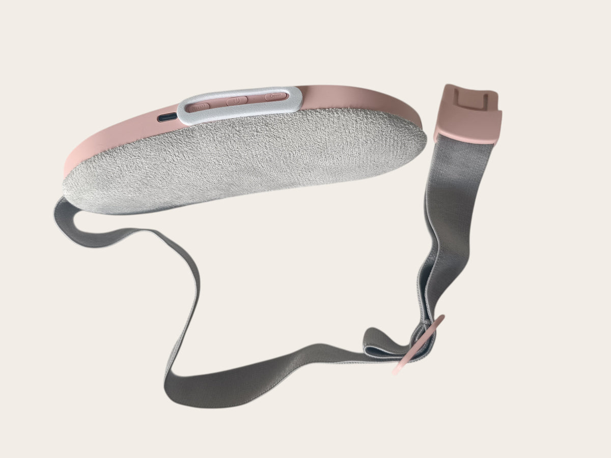 Campus Zone pink wearable menstrual heating pad with soft fabric surface, adjustable strap, and USB-C charging port.